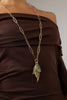 Handmade brass botanical charm necklace with textured leaf drops and raw resin stone

