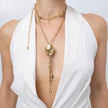 Kira Chanel necklace layered with brass chain, pearl and crystal pendant detail