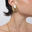 Model wearing Kira Clip brass pearl cluster clip-on earring, side profile