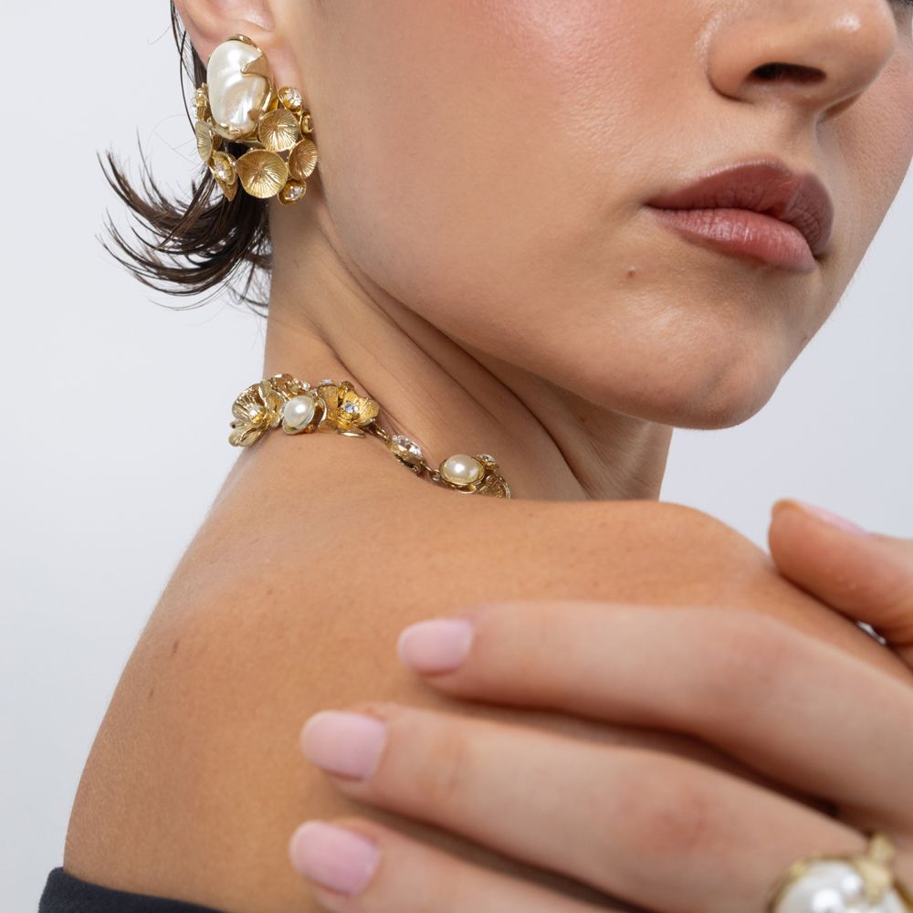 Kira Clip handmade brass pearl earring worn with matching necklace, close-up