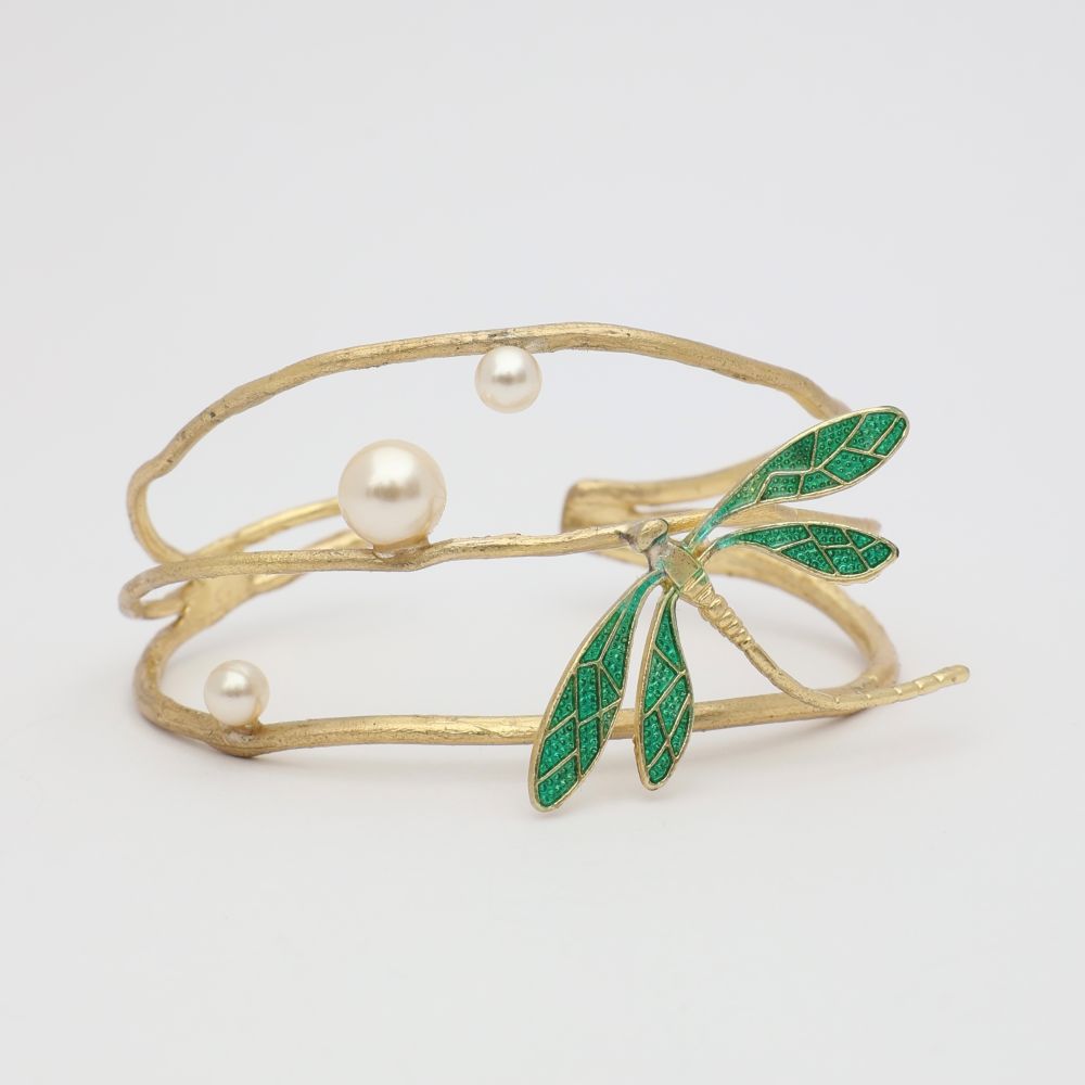 Gold bracelet with green leaves and pearls on a light gray background