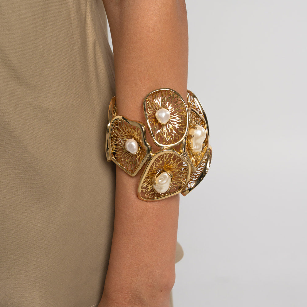 Lore Bracelet — handmade brass wide cuff bracelet with filigree panels and baroque freshwater pearls, worn on model