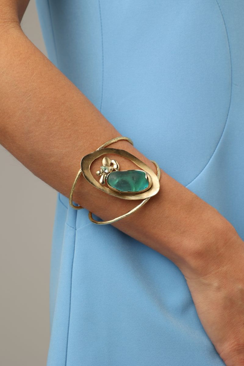 Pulse Bracelet side view on model — handmade brass sculptural statement cuff with organic stone centerpiece
