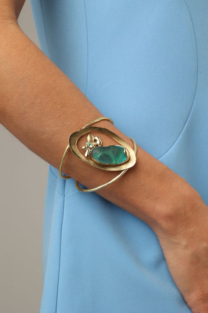 Pulse Bracelet side view on model — handmade brass sculptural statement cuff with organic stone centerpiece
