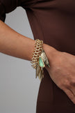 Handmade brass bold statement bracelet with sculptural leaf drops, artisan jewelry made in Greece