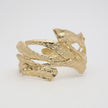 Nerra Bracelet detail — handmade brass open cuff bracelet with raw textured surface and interlocking forms
