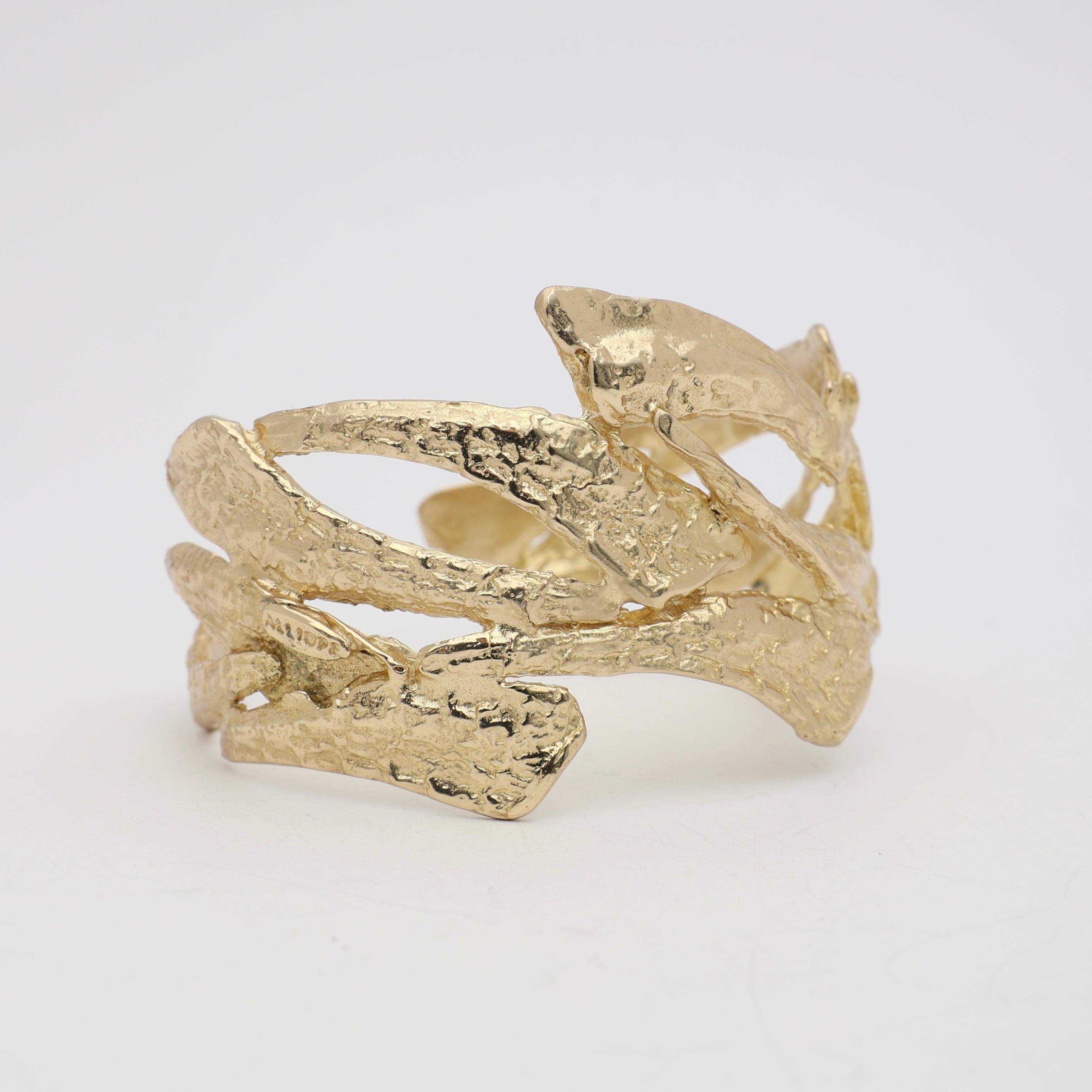 Nerra Bracelet detail — handmade brass open cuff bracelet with raw textured surface and interlocking forms
