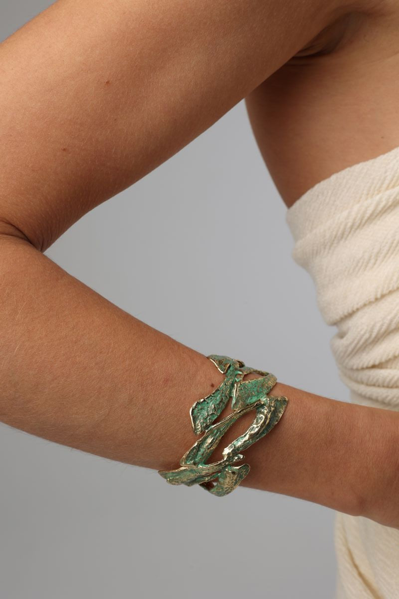 Nerra Bracelet on model — handmade brass sculptural wide cuff worn on wrist
