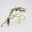 Dragonfish Bracelet detail — handmade oxidised brass creature motif with crystal accents and fluid brass tendrils