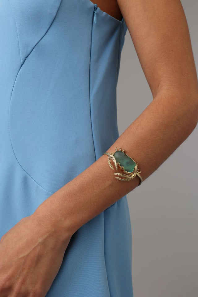 Crabby Bracelet on model — handmade brass artisan cuff bracelet with nature-inspired crab sculpture