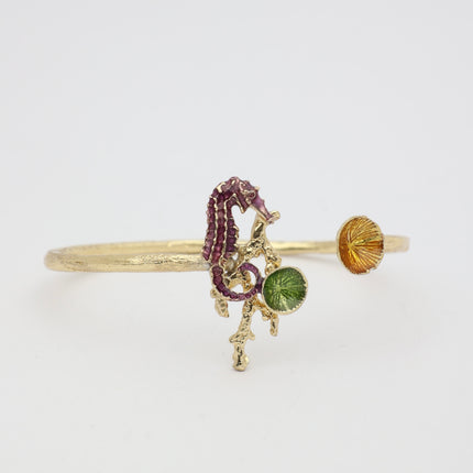 Coralia Bracelet — handmade brass open cuff with enamel seahorse and limpet shell details
