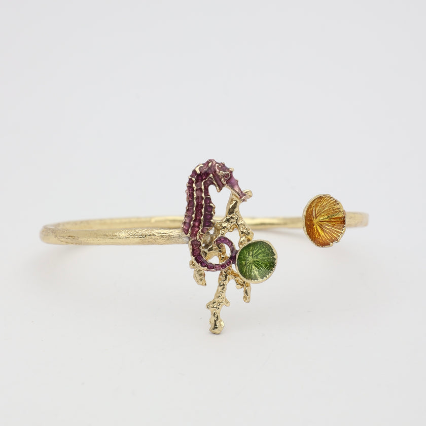 Coralia Bracelet — handmade brass open cuff with enamel seahorse and limpet shell details
