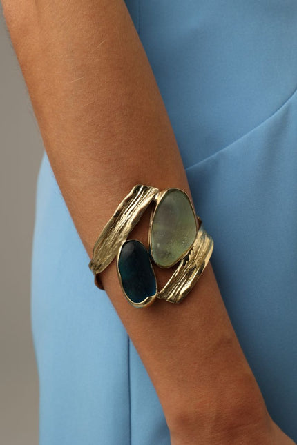 handmade brass gemstone cuff bracelet with two organic freeform stones on model, wrist view
