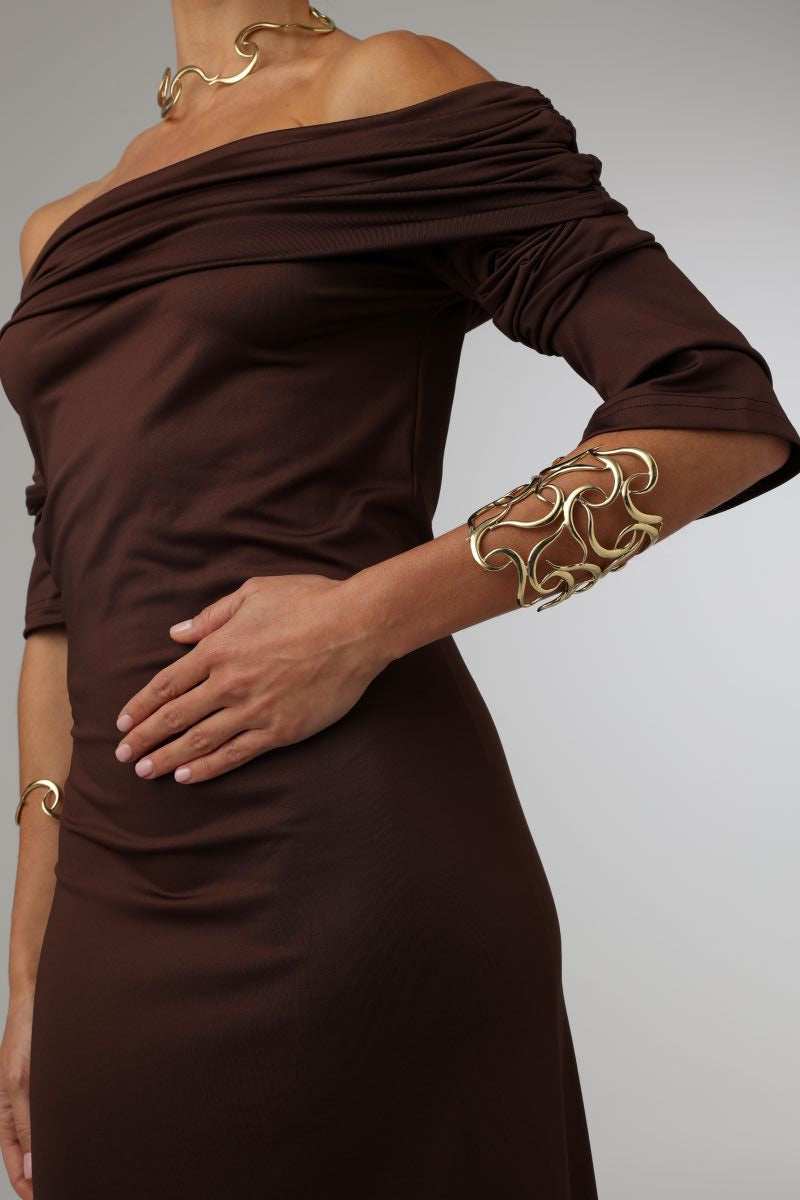 Eternity Bracelet — handmade brass wide sculptural cuff bracelet worn on model with matching necklace