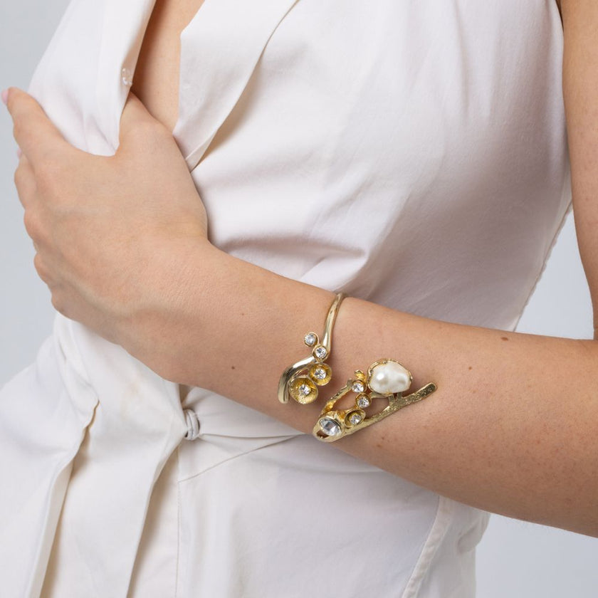 Nerea handmade brass pearl cuff bracelet worn on wrist, close-up