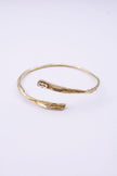 Glade gold wrap cuff bracelet with organic branch texture and clear baguette-cut crystal on a white background