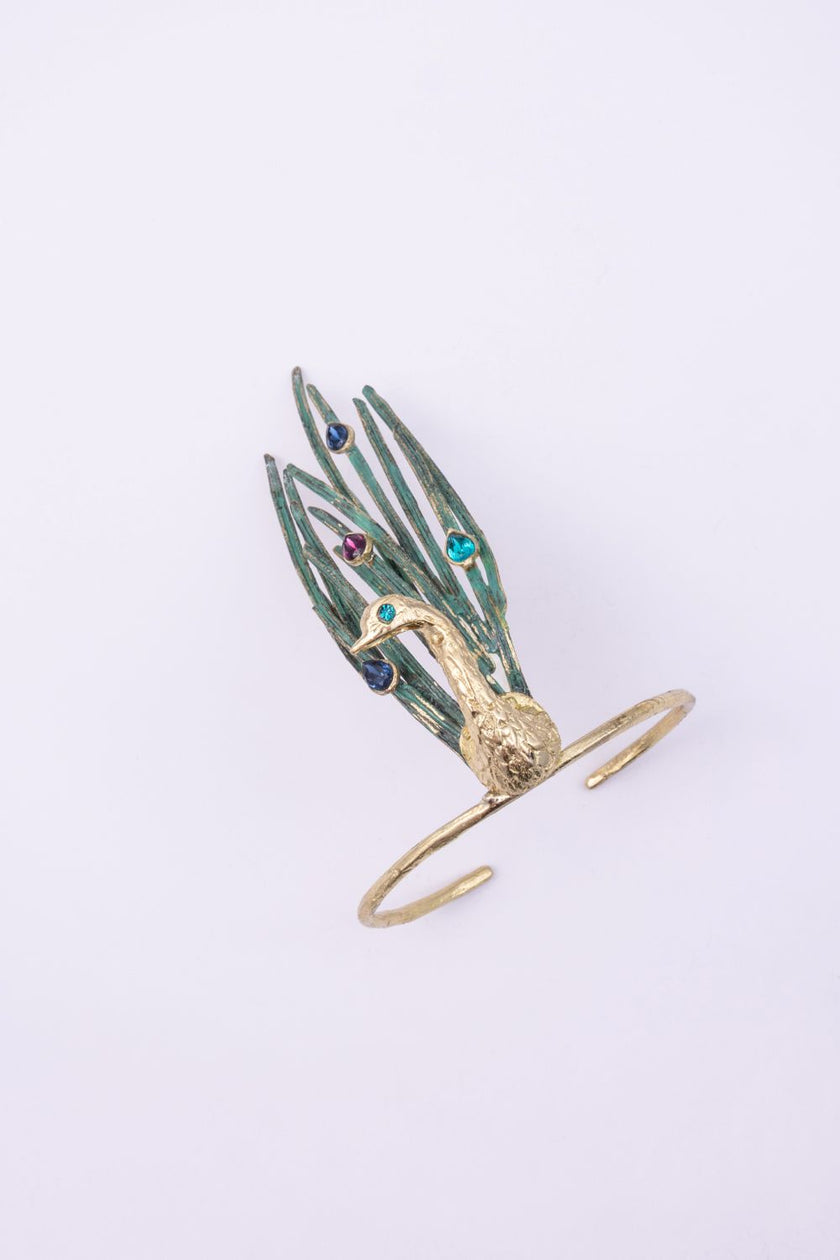 Handmade gold peacock cuff bracelet with green feathers and colorful teardrop crystals, side view