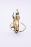 Handmade gold peacock statement bracelet with smoky crystals and sculpted feathers, front view
