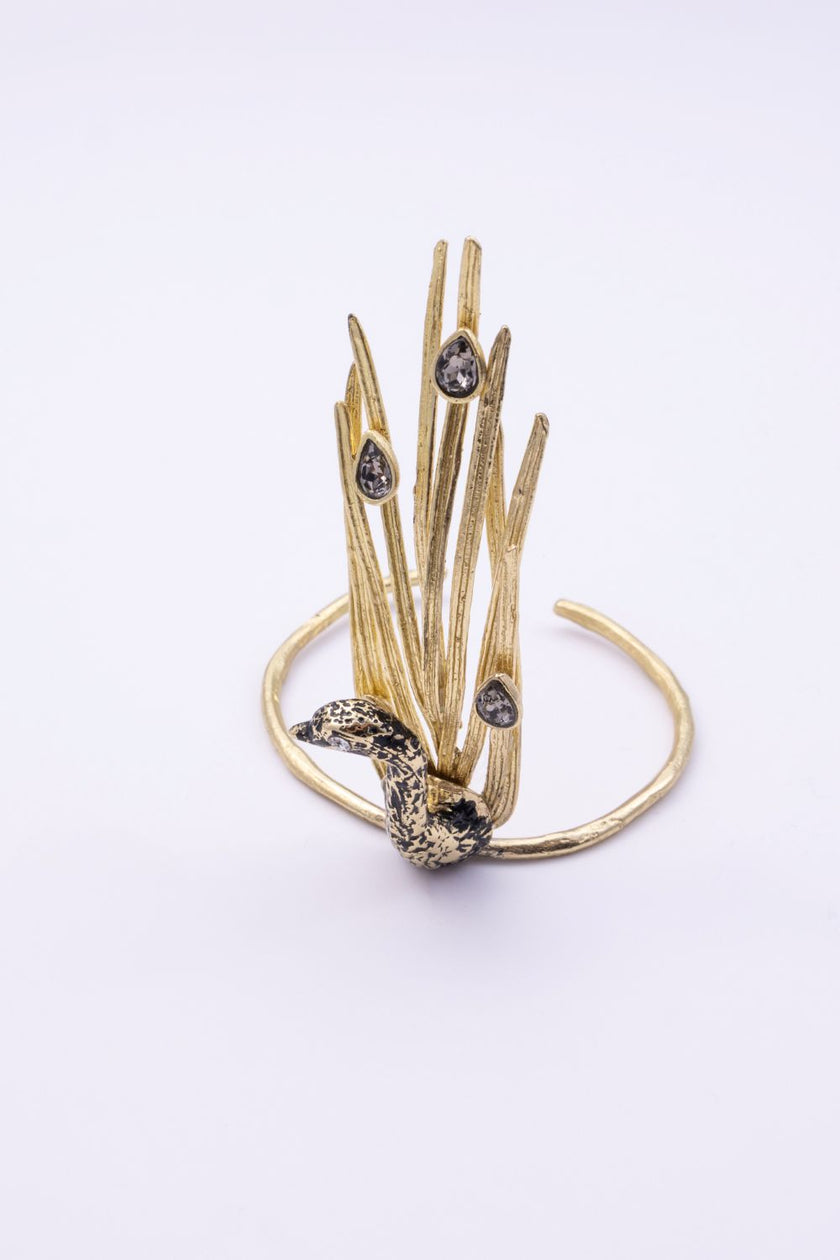 Handmade gold peacock statement bracelet with smoky crystals and sculpted feathers, front view