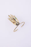 Handmade gold peacock bracelet with green, pink and smoky crystal feather tips, angled view
