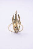 Gold peacock cuff bracelet with black oxidized bird and multicolor pastel crystals, front view on white background