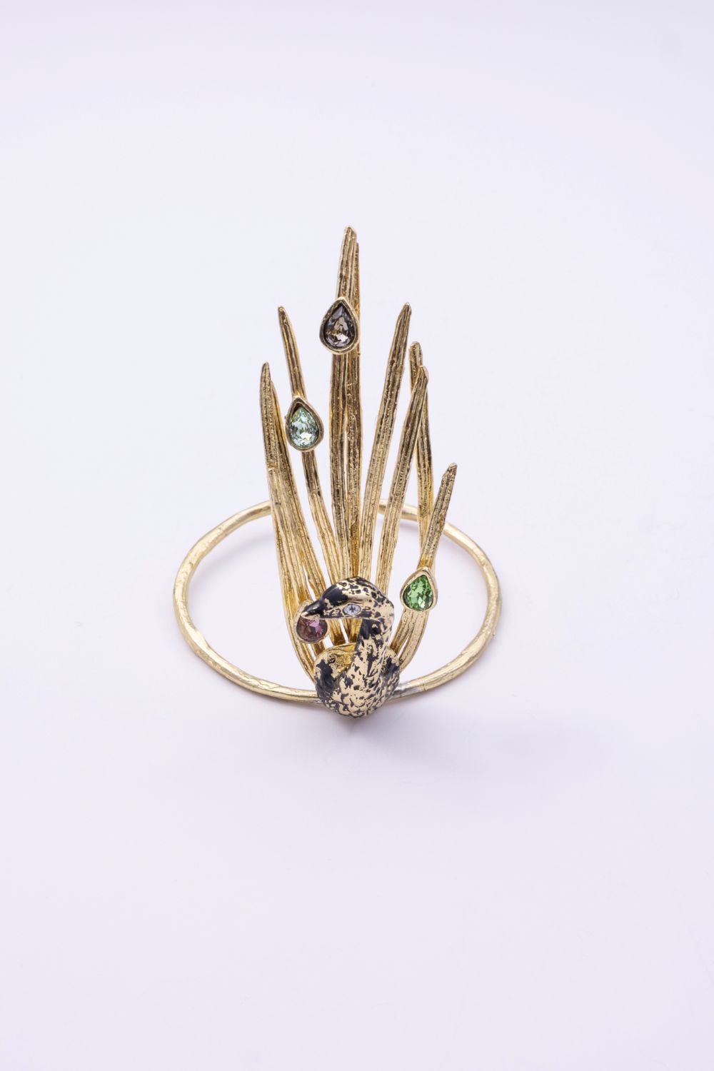 Gold peacock cuff bracelet with black oxidized bird and multicolor pastel crystals, front view on white background