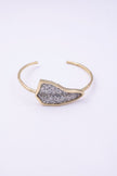 Edge handmade gold-plated brass cuff bracelet with clear silver crystal plate on a white background