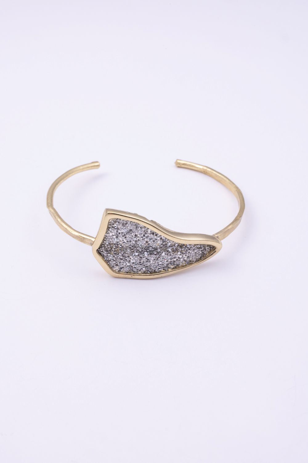 Edge handmade gold-plated brass cuff bracelet with clear silver crystal plate on a white background