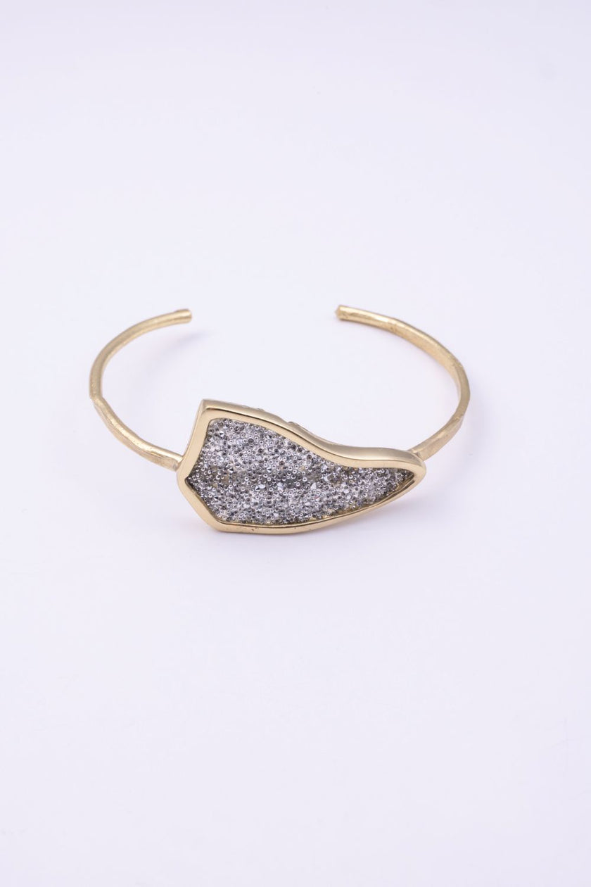 Edge handmade gold-plated brass cuff bracelet with clear silver crystal plate on a white background