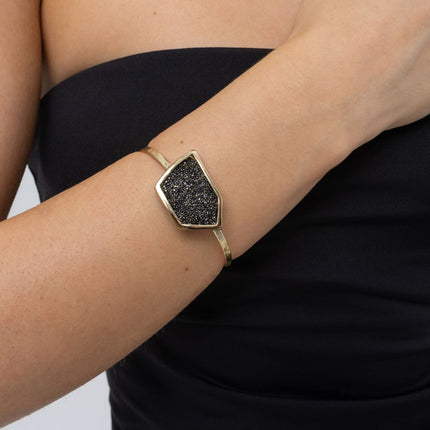 Woman wearing handmade gold cuff bracelet with geometric crystal panel, Glitter Kiss collection