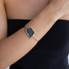 Handmade gold cuff with sculptural geometric crystal panel worn on the wrist