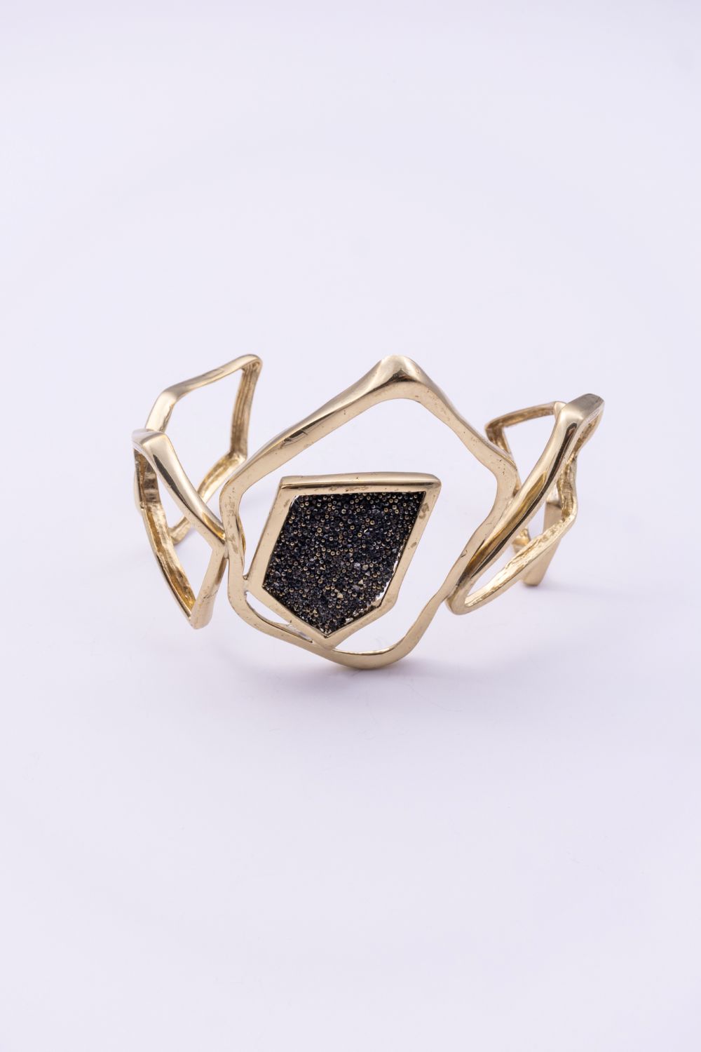 Handmade gold statement cuff with open geometric design and crystal panel, handmade in Greece