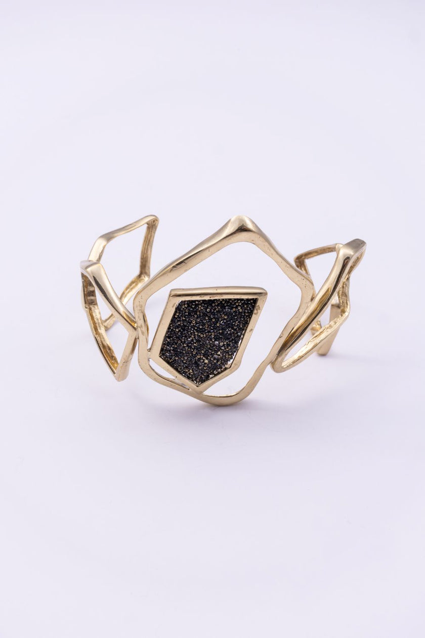 Handmade gold statement cuff with open geometric design and crystal panel, handmade in Greece
