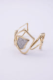 Glow cuff bracelet with sculptural gold lines and crystal centre