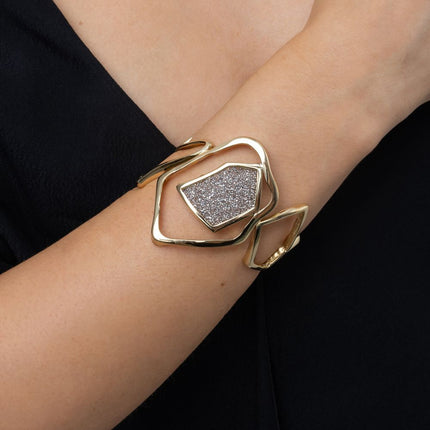 Handmade open gold cuff with sculptural frame and sparkling crystal panel