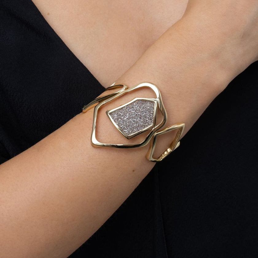 Handmade open gold cuff with sculptural frame and sparkling crystal panel