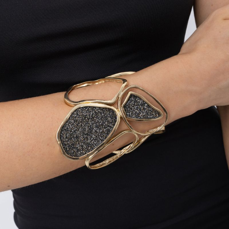 Woman wearing handmade wide gold cuff with organic loops and two crystal panels, Glitter Kiss collection