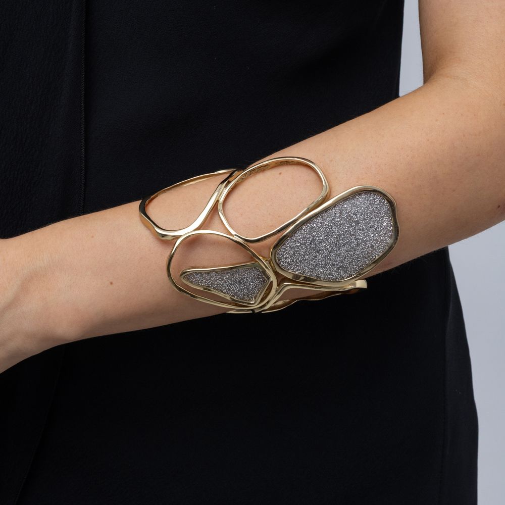 Handmade open gold cuff with flowing loops and sparkling crystal panels