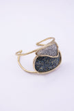 Handmade gold cuff with large oval crystal panel and smaller overlapping crystal panel