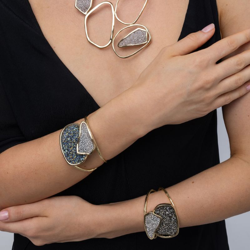 Model wearing two Twin cuff bracelets with a matching sculptural crystal necklace, Glitter Kiss collection