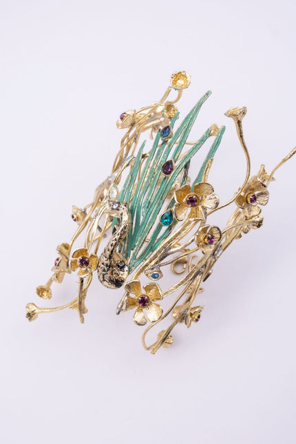 lume handmade gold peacock cuff bracelet with green feathers, flower details and multicolor crystals on a white background