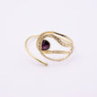 Boteh handmade gold cuff bracelet with hammered texture loops and purple crystal on a white background