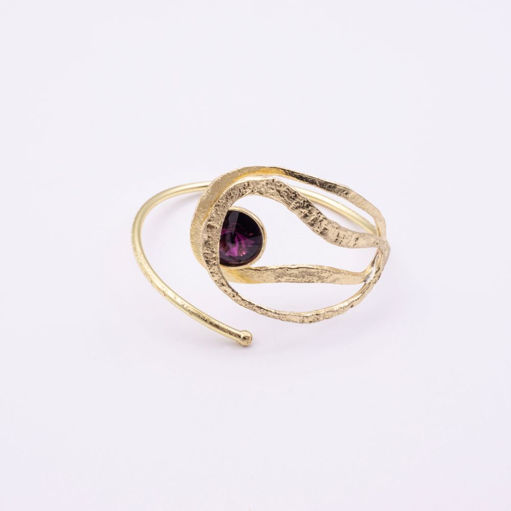 Boteh handmade gold cuff bracelet with hammered texture loops and purple crystal on a white background