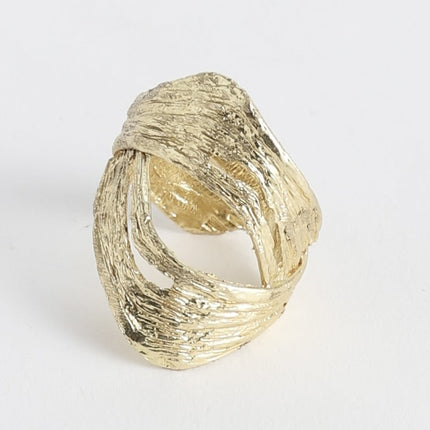 Close-up product shot of handmade brass wide band ring with organic bark-like texture and oval open cutout design — Novel Ring by Kalliope Jewelry, crafted in Greece