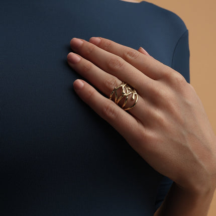 Handmade gold-tone brass wide band open-work ring with intertwining organic branch strands worn on hand — Foggy Ring by Kalliope Jewelry, crafted in Greece