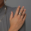 Artisan gold-tone brass fluid wrap ring with baroque pearl worn on hand styled with matching necklace — Swirl Ring by Kalliope Jewelry, crafted in Greece