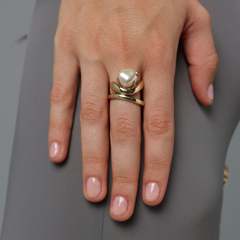 Handmade gold-tone brass double wrap ring with baroque pearl in sculptural prong setting worn on hand — Swirl Layered Ring by Kalliope Jewelry, crafted in Greece