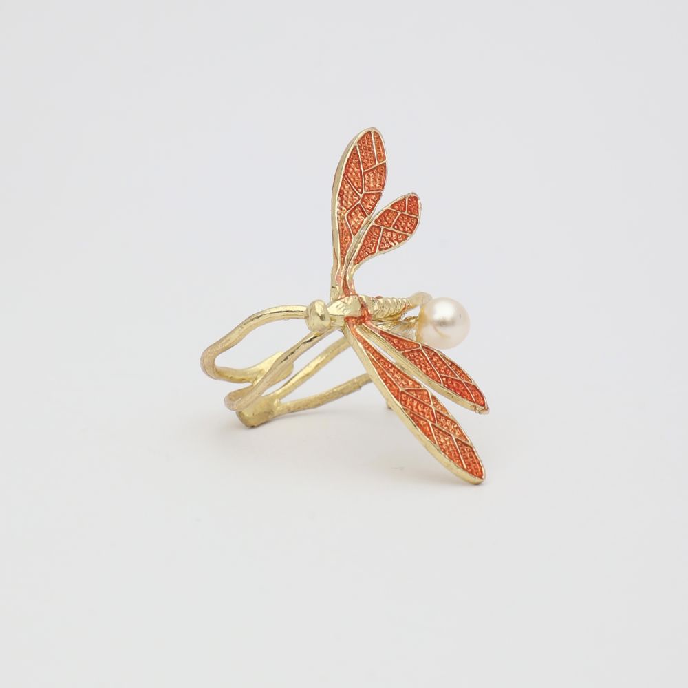 Gold and red leaf-shaped ring on a light gray background