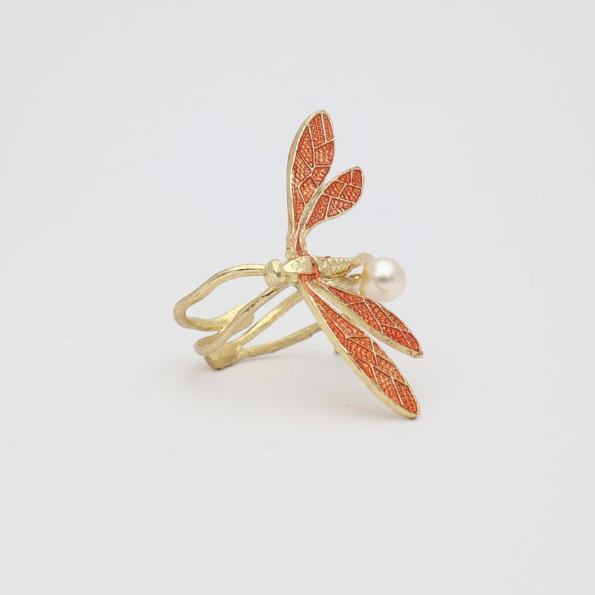 Gold and red leaf-shaped ring on a light gray background