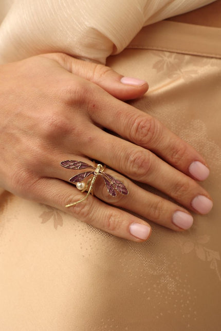 Buzz Ring — handmade brass dragonfly statement ring with enamel wings and freshwater pearl, worn on model